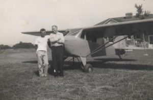 Howard Doland and Ken Slingerland, late 1940's early 1950's standing next to Ken's tail dragger.