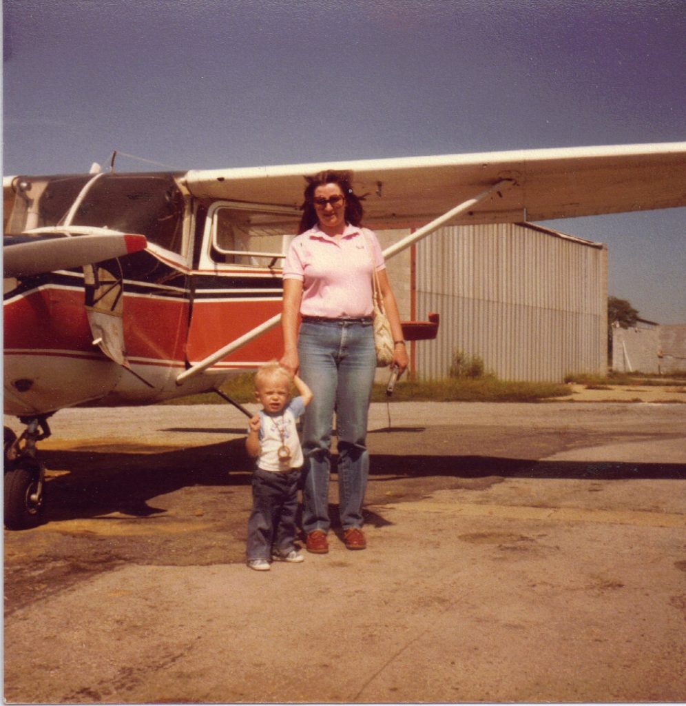 Sister Sue and son Art standing in front of Dad's Cessna 172